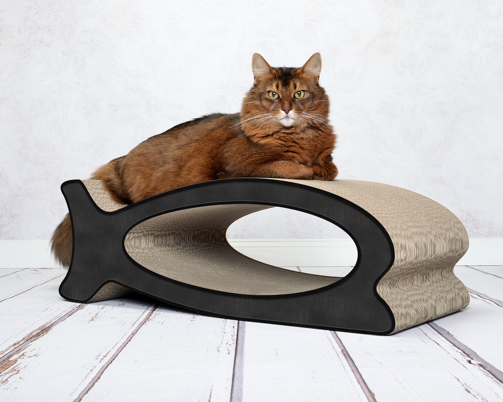 A cat playing and scratching on LE FISH – stylish fish-shaped cardboard cat scratcher