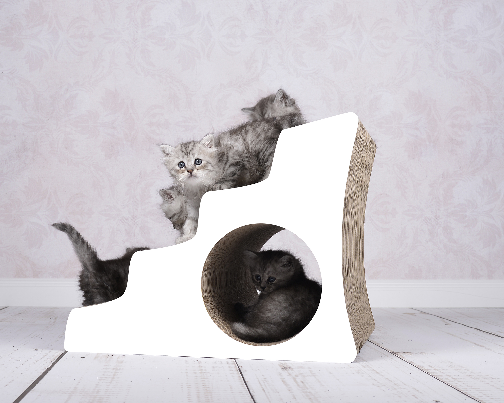 Several cats on LESCALIER designer cardboard cat staircase Several kittens climbing and playing on the stylish LESCALIER cat staircase made of sustainable scratch cardboard, handcrafted in Berlin.